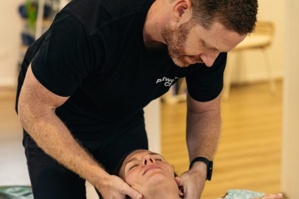Female patient being treated by a chiropractor for neck pain