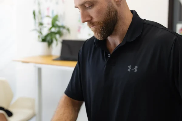 Chiropractor performing hip assessment in Mona Vale clinic